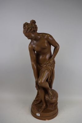 an image of a statue of a man sitting on a rock
