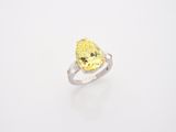 a yellow diamond ring on a white background