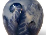 a blue and white vase with a bird on it