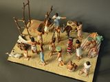 figurines of native people in a desert setting on a table