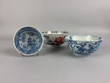 three blue and white bowls with designs on them sitting next to each other