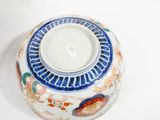 a blue and white vase with a fish design on it