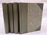 trois livres sont empilés sur une surface blanche