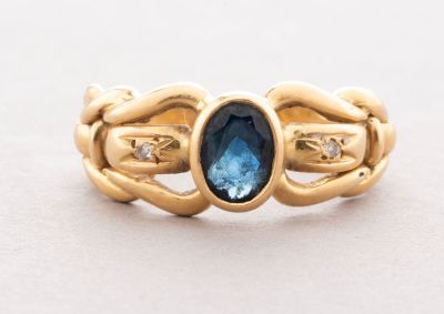 an image of a gold ring with a blue topaz stone