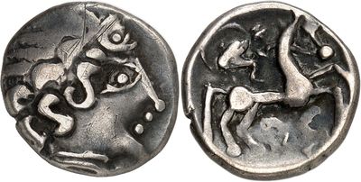 an ancient coin with a horse and rider on it
