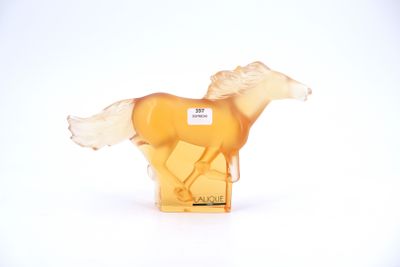a yellow horse figurine that is on a white surface