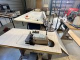 a sewing machine that is sitting on a table in a room