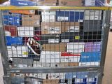a metal cart with many boxes on it in a warehouse