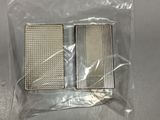 two pieces of metal in a plastic bag on a table