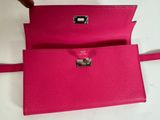 a pink purse with a metal clasp on it