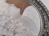 a picture of a picture of a woman in a dress in a broochle