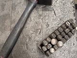 an image of a hammer and some nuts on a workbench