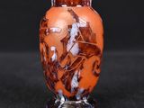 a small vase that is sitting on a black surface