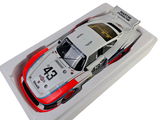 a model of a race car in a white box