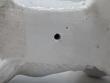 a white vase with a hole in the middle of it