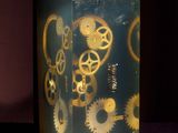 a box with a clock inside of it on a purple surface