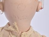 a doll that has a hair band on it ' s head