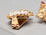 two pairs of gold and pearl earrings on a white surface