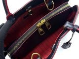 an image of a black and red handbag on a white background