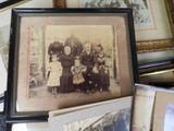 a lot of old family pictures on the table