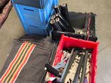 a pile of tools in a blue crate on the floor