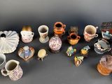 many different types of vases sitting on a table