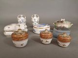 several different types of porcelain containers and lids on a gray surface