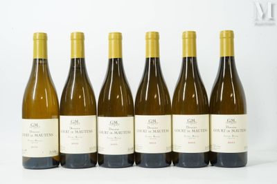 six bottles of wine are lined up in a row on a white surface