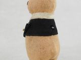 a small stuffed animal that is wearing a black and white shirt