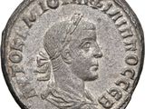 a silver coin with a woman ' s head and a crown on it