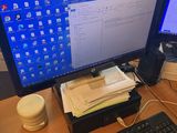 a computer desk with two monitors and a keyboard on it