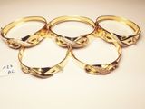 four gold rings with diamonds on them sitting on top of a table