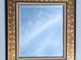 a picture of a mirror hanging on the wall