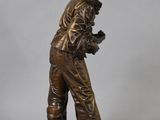 bronze statue of a man in a gas mask on a base