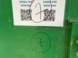 a green trash can with a qr code on it