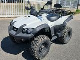 an image of a white four wheeler atv parked in a parking lot