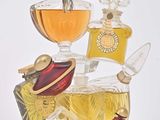 many different types of perfumes on display on a white surface