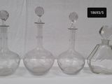 three glass bottles that are sitting next to each other
