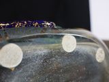 a glass vase that has a blue and gold decoration on it