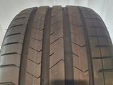a close up of a car tire on a white surface