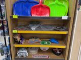 many different colored shovels on a shelf in a store