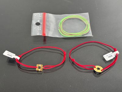 two red and green cords that are on a table