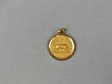 a close up of a gold medal on a white surface
