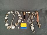a lot of jewelry that is laying out on the table