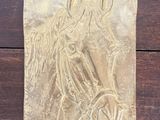 a close up of a metal plaque with a horse on it