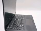 a laptop that is open on a white surface