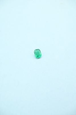 a green emerald stone on a white surface