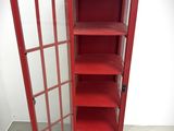 a red phone booth with a glass door and shelves