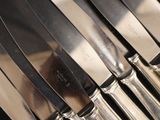 a lot of knives that are sitting on a table