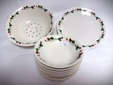 four white bowls with red and green designs are stacked on top of each other